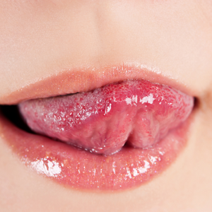 Woman licking her lips with tongue.